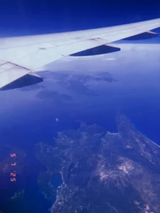 Airplane wing over earth, traveling around the world, number of airline flights taken
